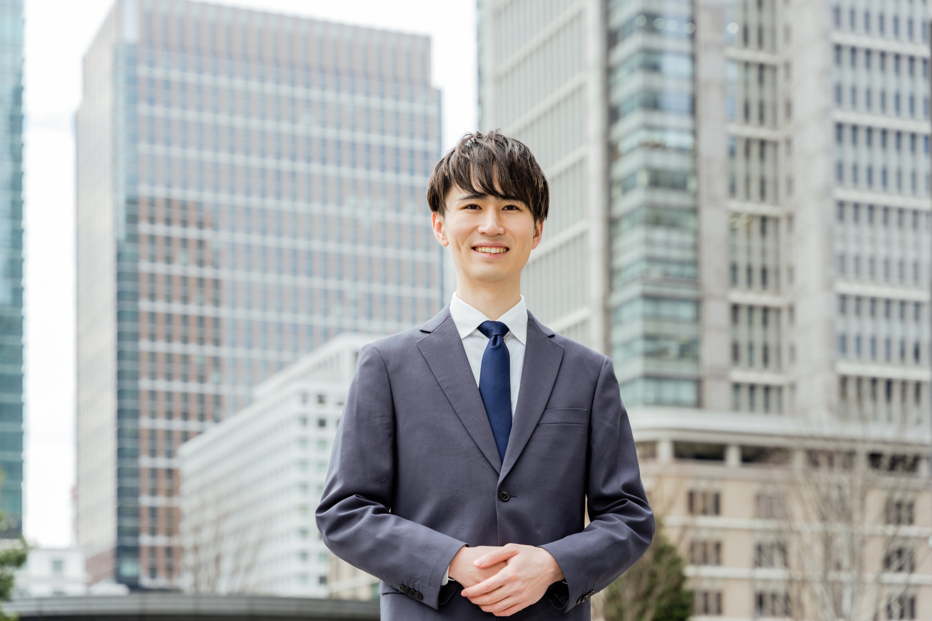 In the business district, a man of the real estate concierge looking at the camera in front of the business suit